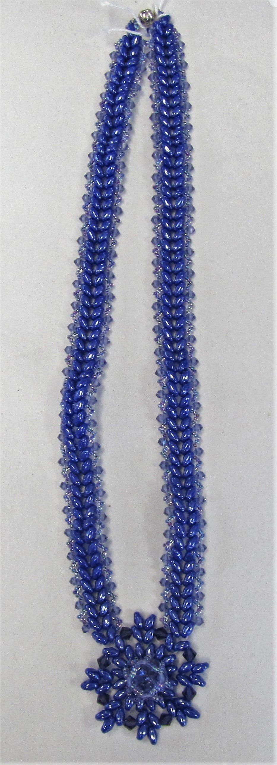 Handcrafted blue beaded pendant on blue beaded necklace