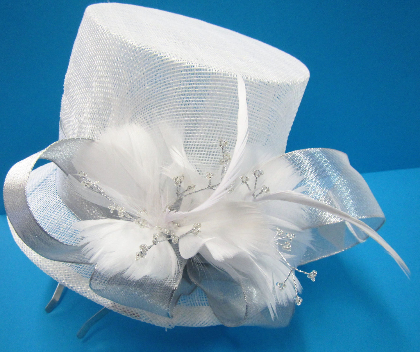 Handcrafted white bridal top hat fascinator with silver band and feathers on a hair band