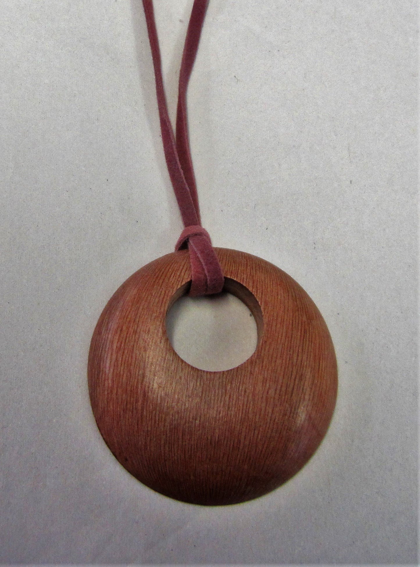 Handcrafted wooden pendent on pink suede necklace