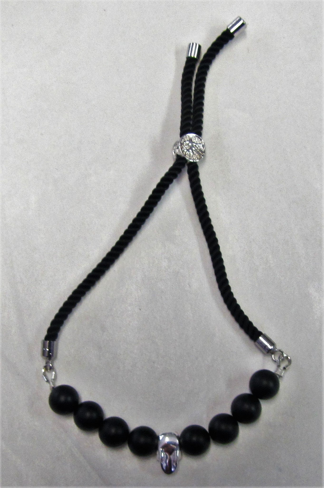 Handcrafted cord bracelet with sterling silver skull