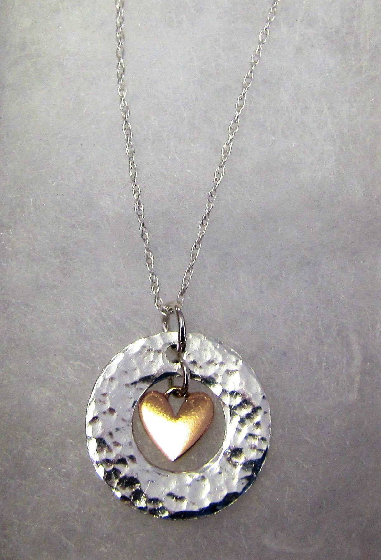 Handcrafted 925 sterling silver hammered circle with hanging rose gold heart necklace