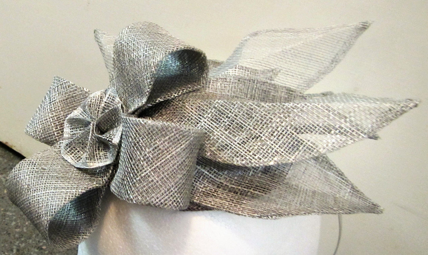 Handcrafted silver fascinator with bow and leaves on a hair band