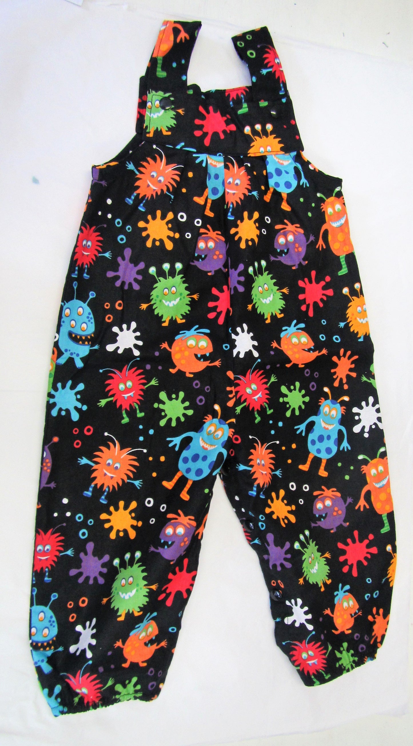 Handcrafted Black and various coloured monsters romper 12-18 months