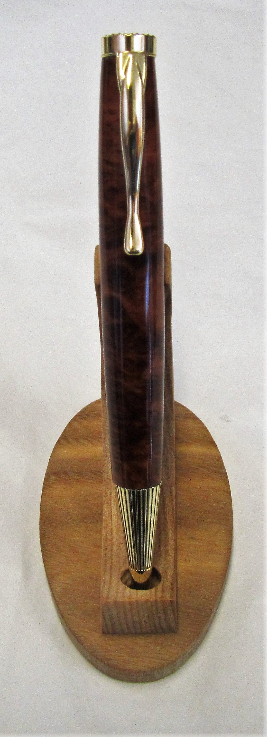 Handcrafted Thuya Burr wood pen with various fittings and pen types.