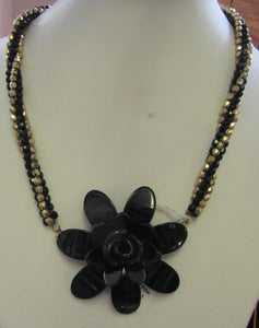 Handcrafted black flower pendant on gold and black beaded necklace