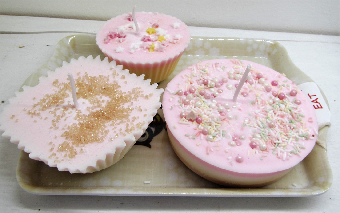 Handcrafted beautiful cake candles on a tray