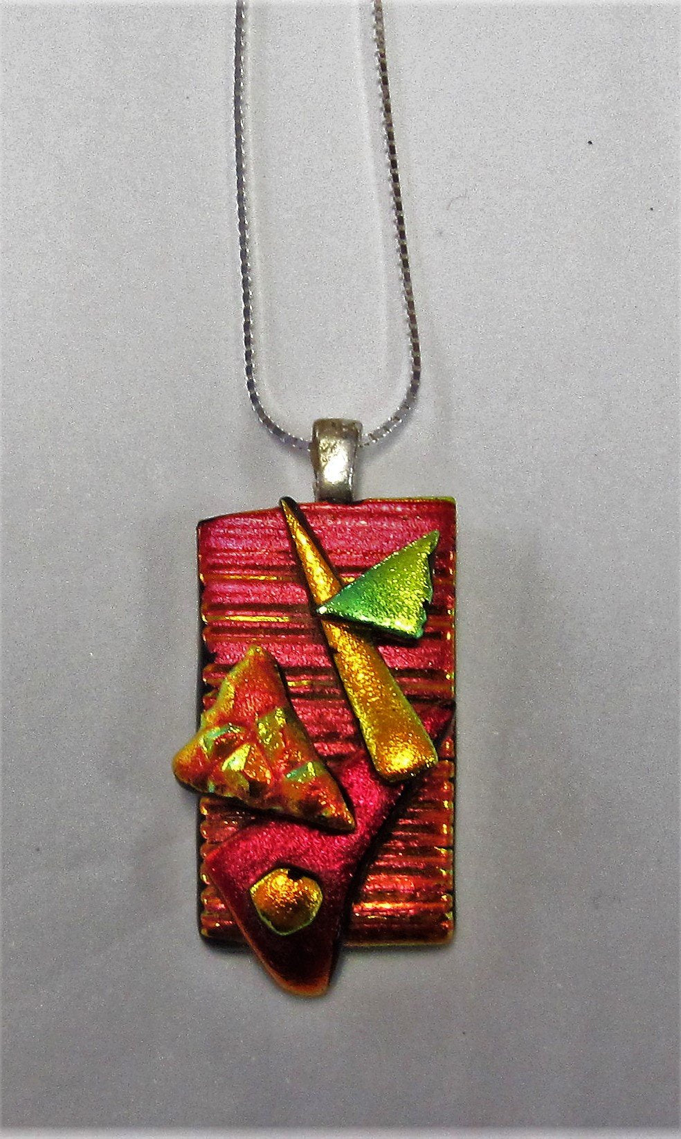 Handcrafted dichroic glass pendant on a sterling silver necklace