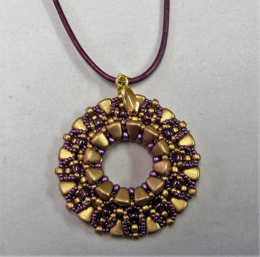 Handcrafted purple and gold beaded pendant on purple leather