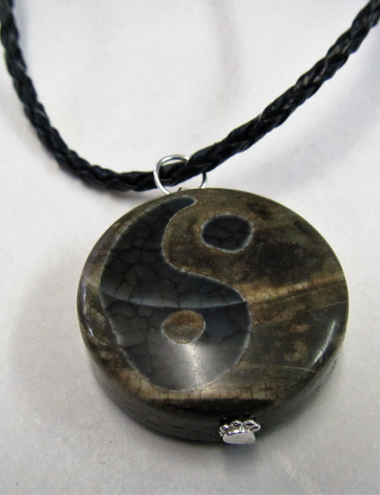 Handcrafted yin and yang agate pendant on leather necklace