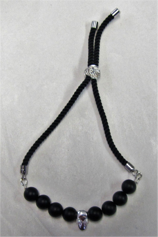 Handcrafted cord bracelet with sterling silver skull
