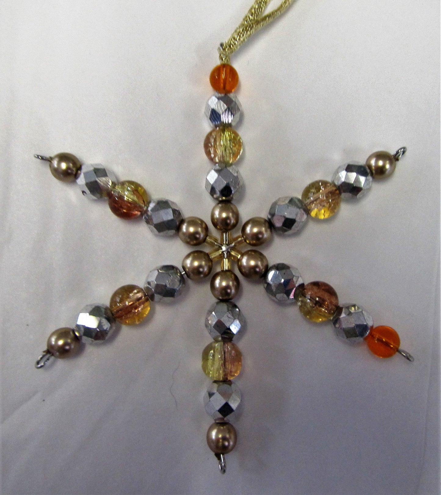 Various beautiful handcrafted beaded star tree decorations