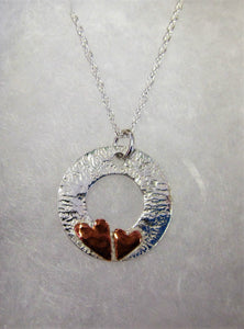 Handcrafted 925 sterling silver reticulated disk with hammered copper hearts necklace