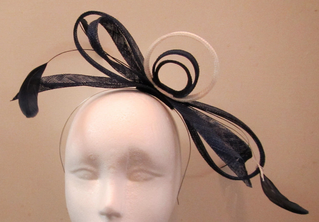 Handcrafted blue and white bow fascinator with blue feathers on a hair band