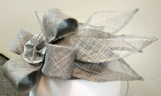 Handcrafted silver fascinator with bow and leaves on a hair band