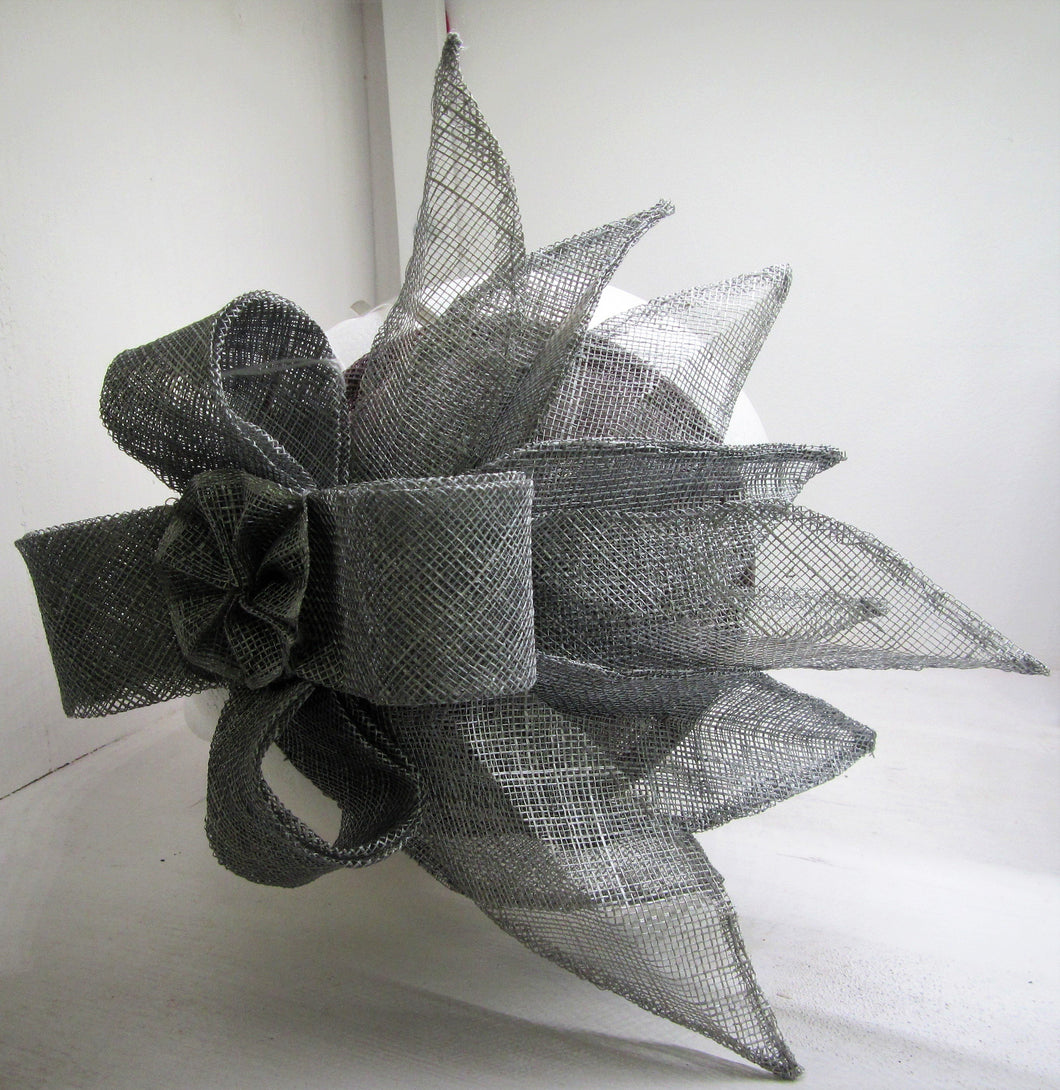 Handcrafted silver fascinator with bow and leaves on a hair band