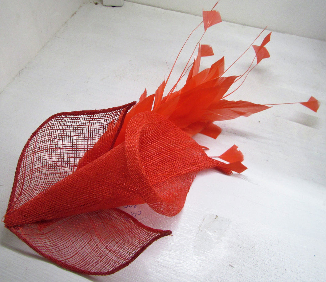 Handcrafted burnt orange Lilly fascinator with burnt orange feathers on a clip