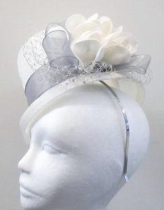 Handcrafted white bridal top hat fascinator with silver ribbon, netting and roses on a hair band