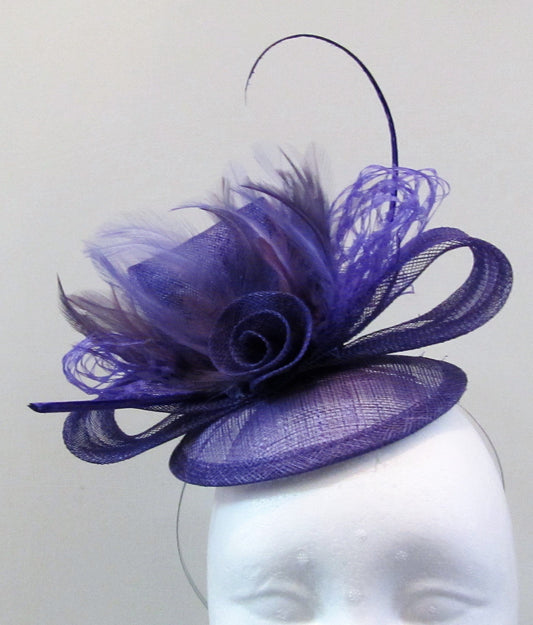 Handcrafted purple fascinator with bow, a flower and purple feathers on a hair band or hair clip