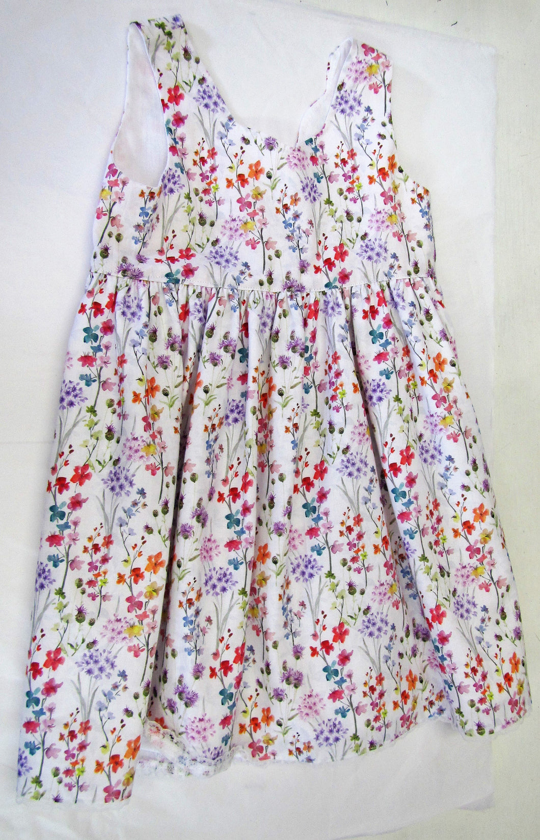 Handcrafted white dress with various coloured flowers and fully lined 4-5 years