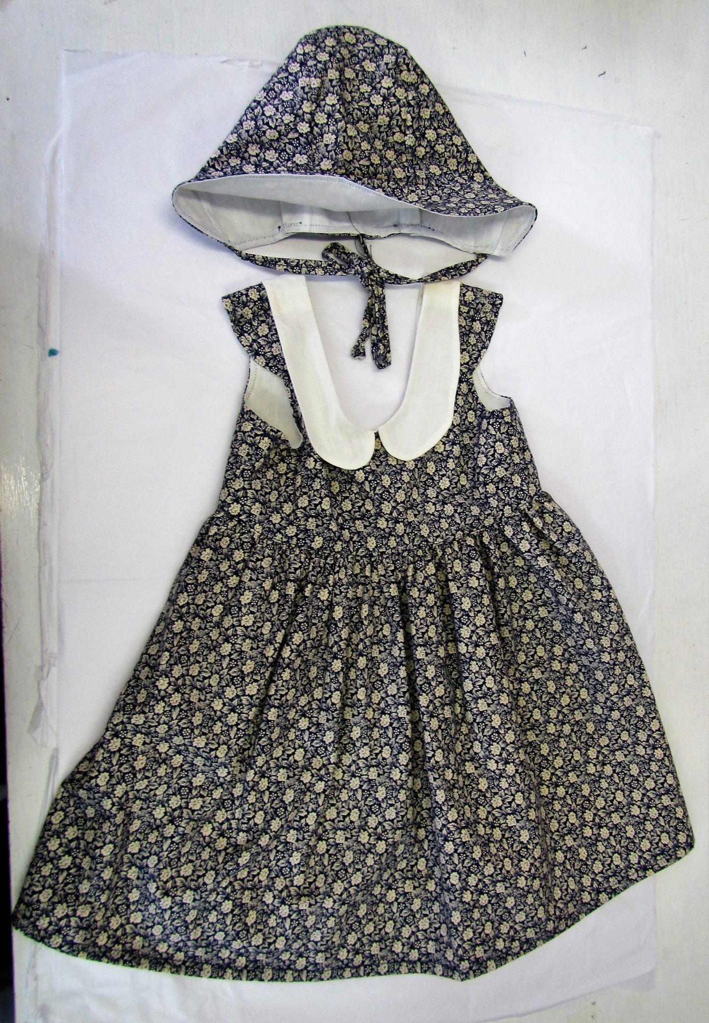 Handcrafted Blue and cream floral dress and fully lined with bonnet 12-18 months