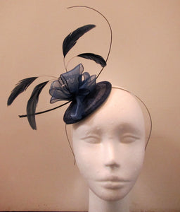 Handcrafted small blue flower and feather fascinator on a headband