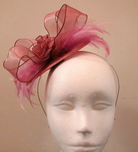 Handcrafted small pink flower and feather fascinator on a headband