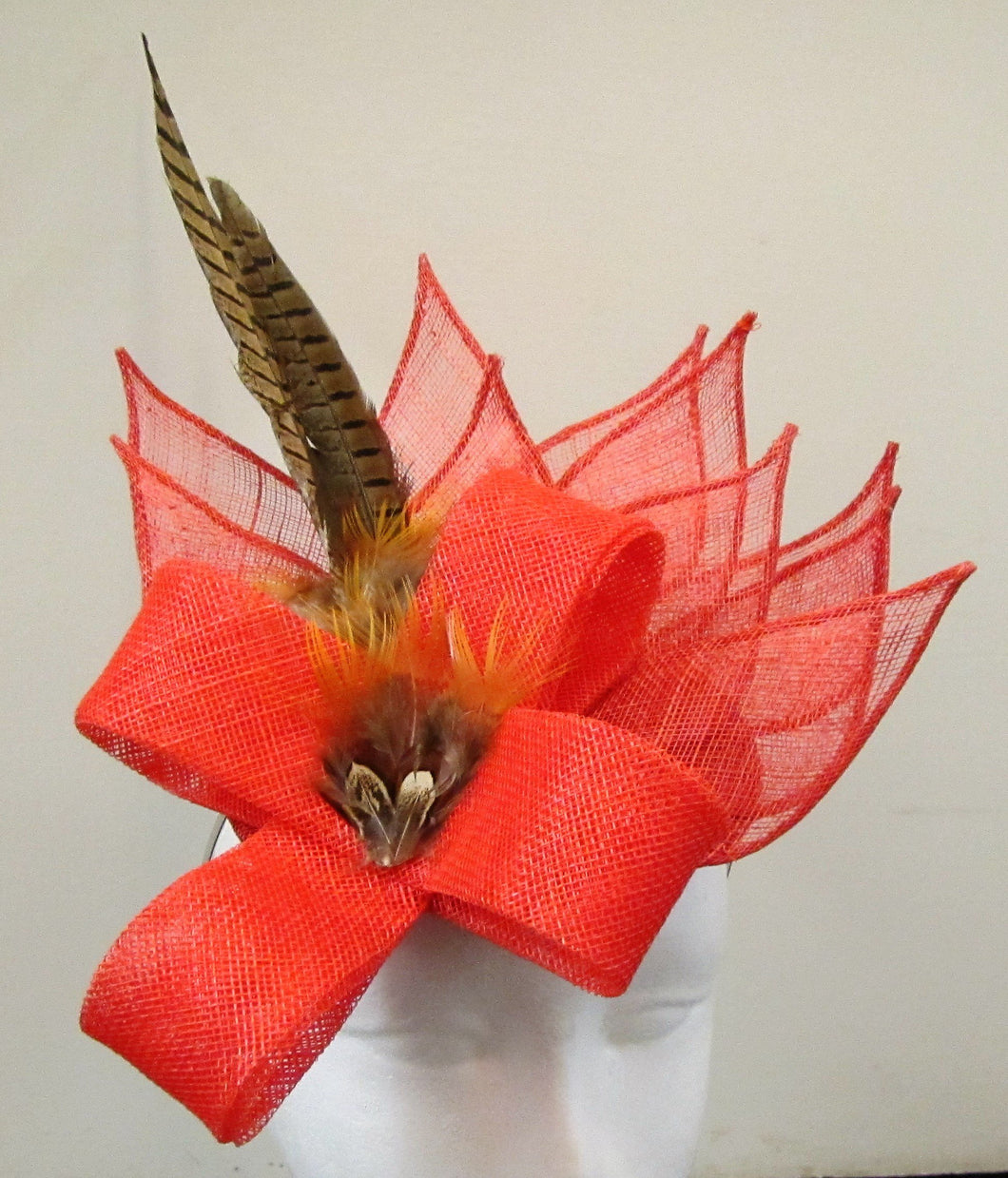 Handcrafted burnt orange fascinator with leaves, bow and pheasant feathers on a hair band
