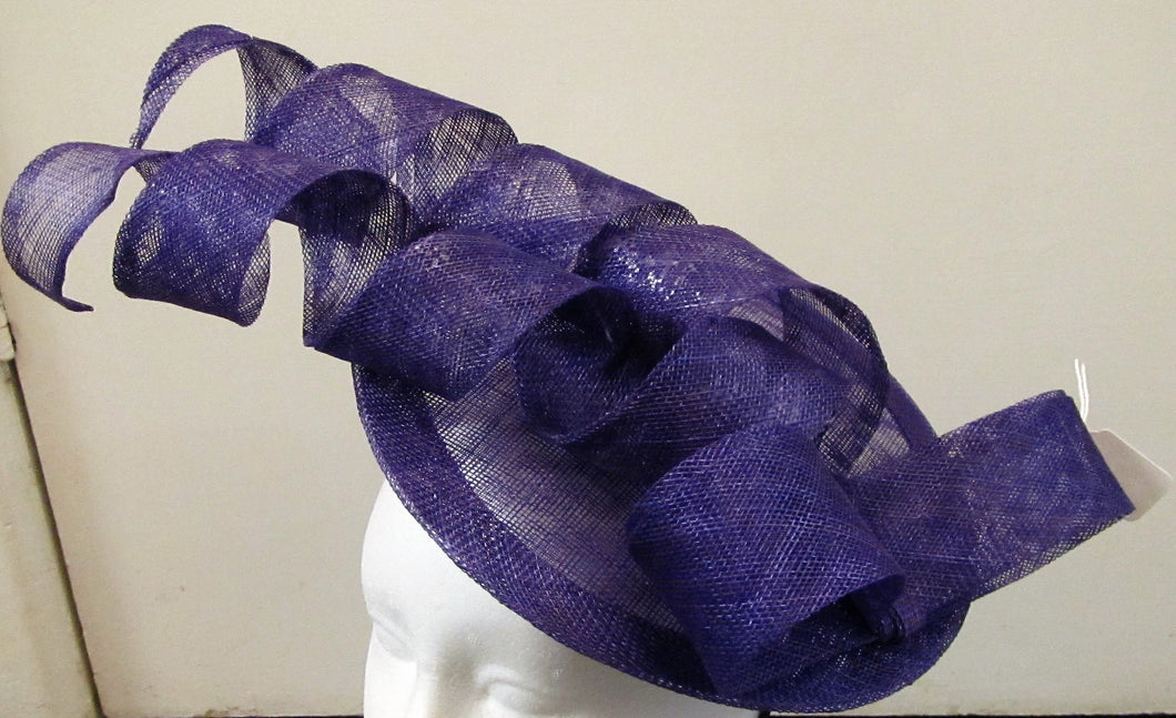 Handcrafted purple disk with spirals and bow fascinator on a headband