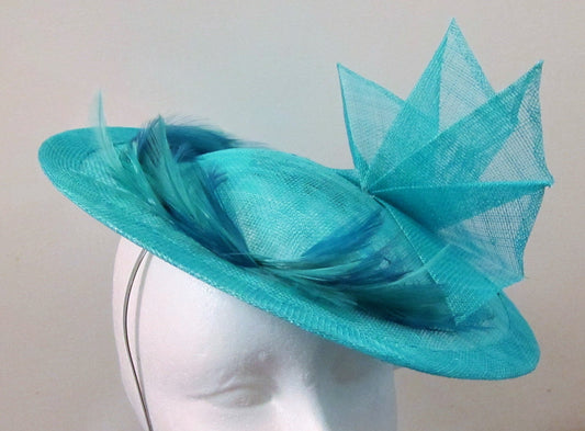 Handcrafted turquoise disk with fan and feathers fascinator on a headband