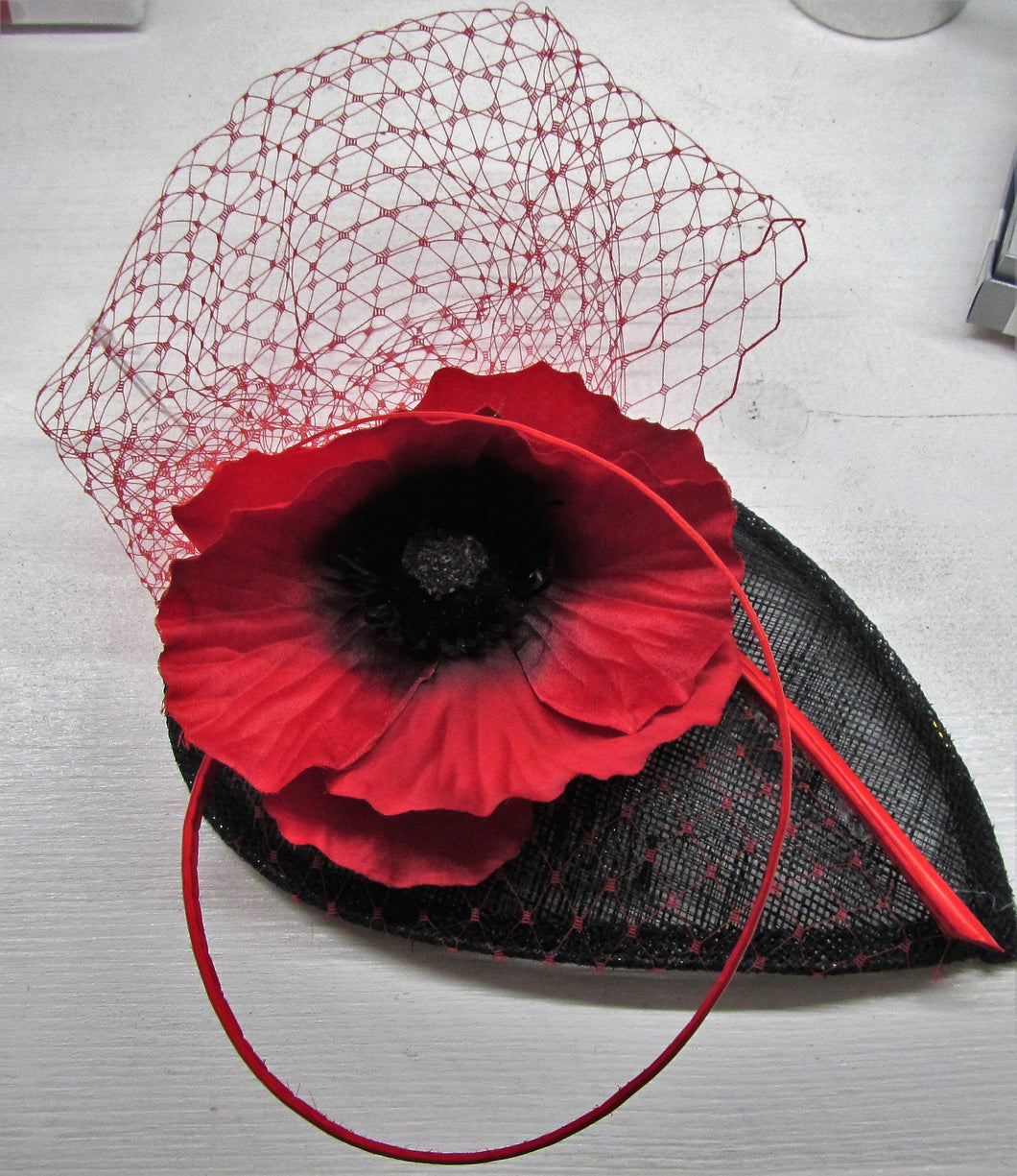 Handcrafted red and black poppy fascinator on a hair comb