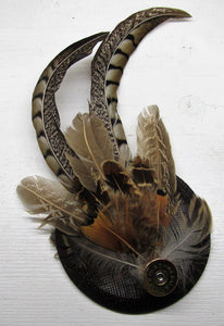 Handcrafted small pheasant feather with cartridge fascinator on a comb slide