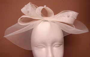 Handcrafted white bridal hair bow piece with pearls on a headband
