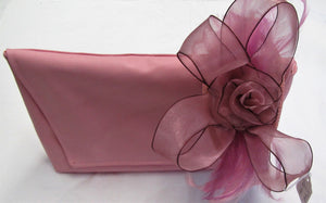 Handcrafted small pink flower and feather fascinator on a headband