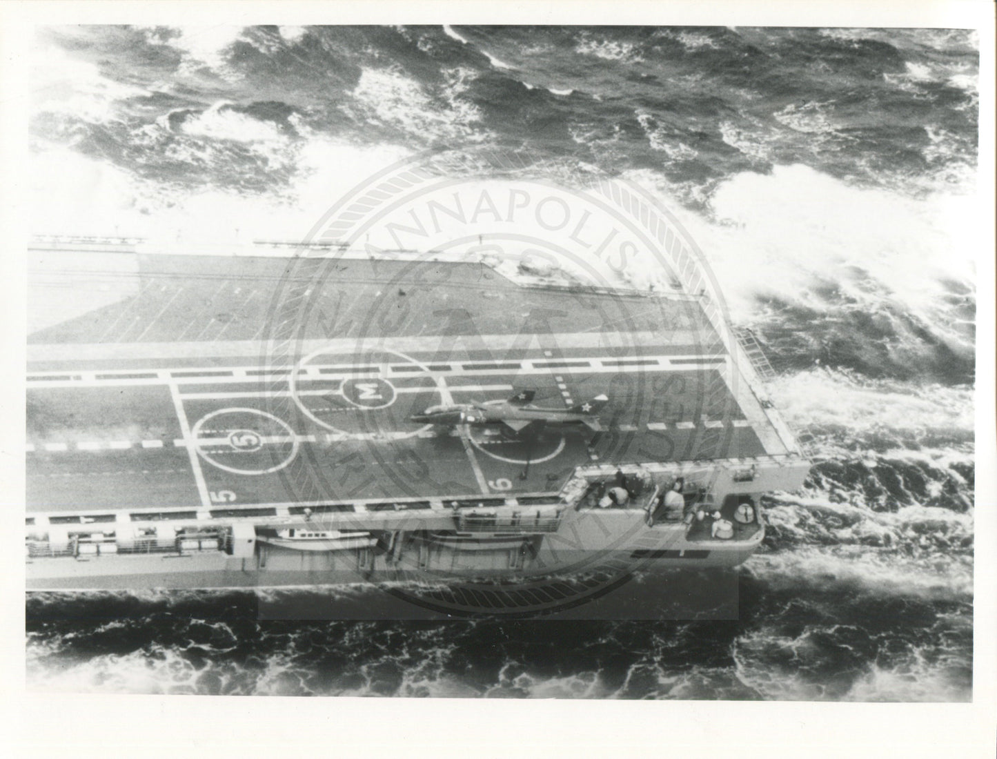 Official U.S. Navy photo of Soviet Kiev class aircraft carrier Minsk underway with an aircraft hovering above the deck.