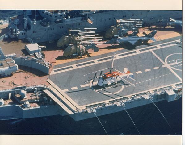 Official U.S. Navy photo of Soviet Kiev class aircraft carrier Minsk underway with an aircraft hovering above the deck.